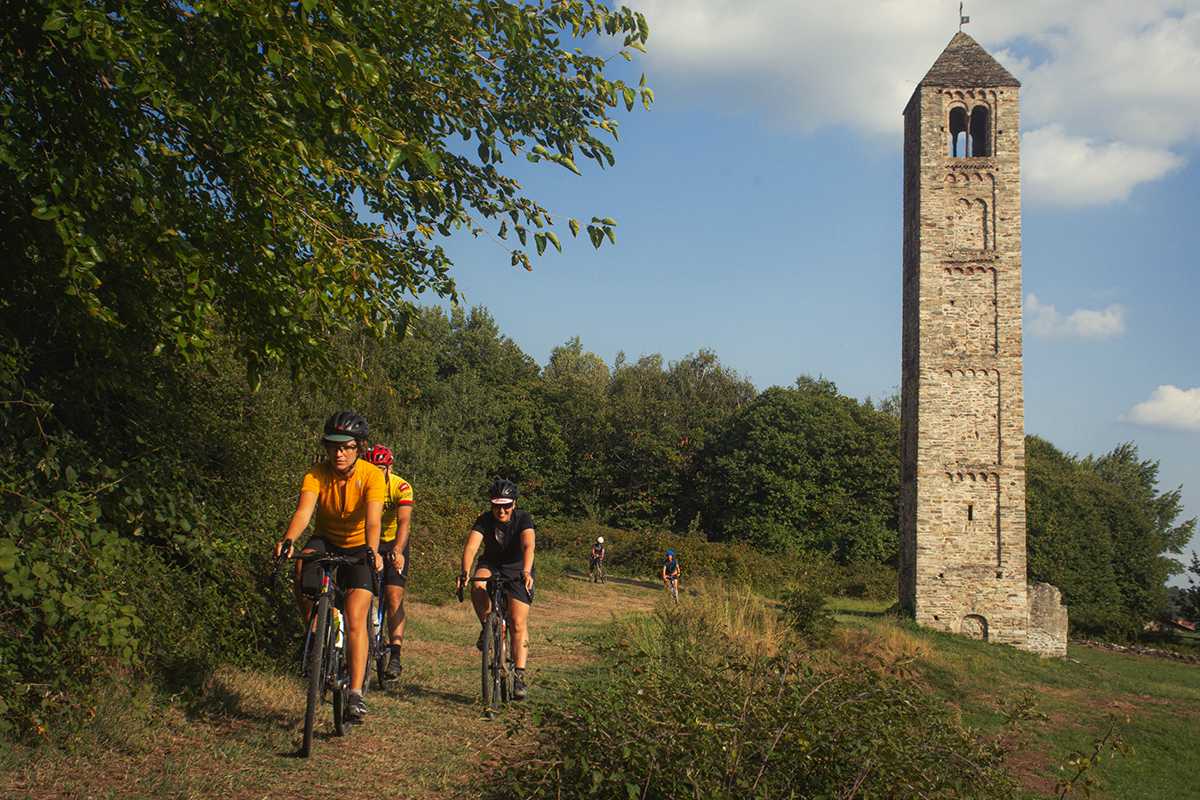 Coppia ciclisti con campanile sullo sfondo foto di Paolo Ciaberta Erratico Gravel
