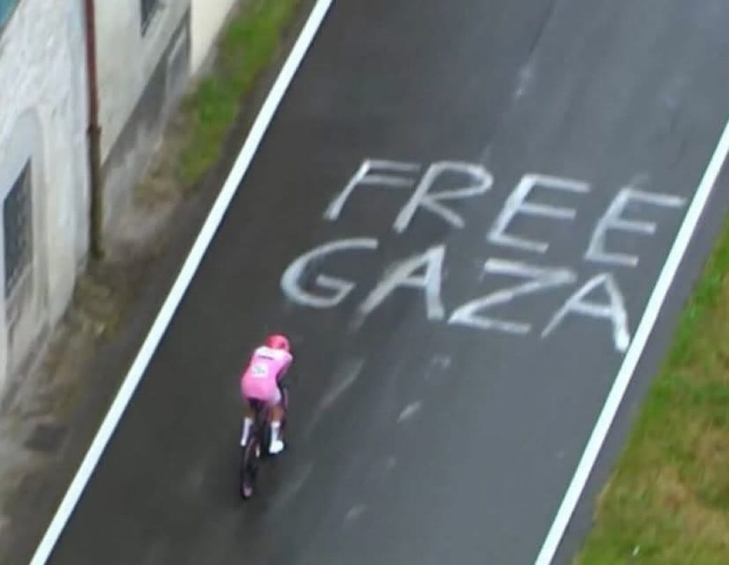 Scritta Free Gaza lungo il percorso della decima tappa crono Lucca-Pisa Giro d'Italia 2025